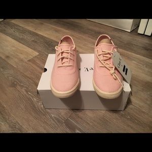 Pale pink TOMS.